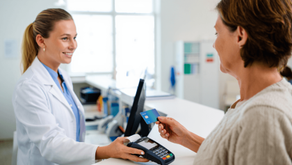 output:  Moderner Krankenhausflur mit Empfang und Pflanzen.